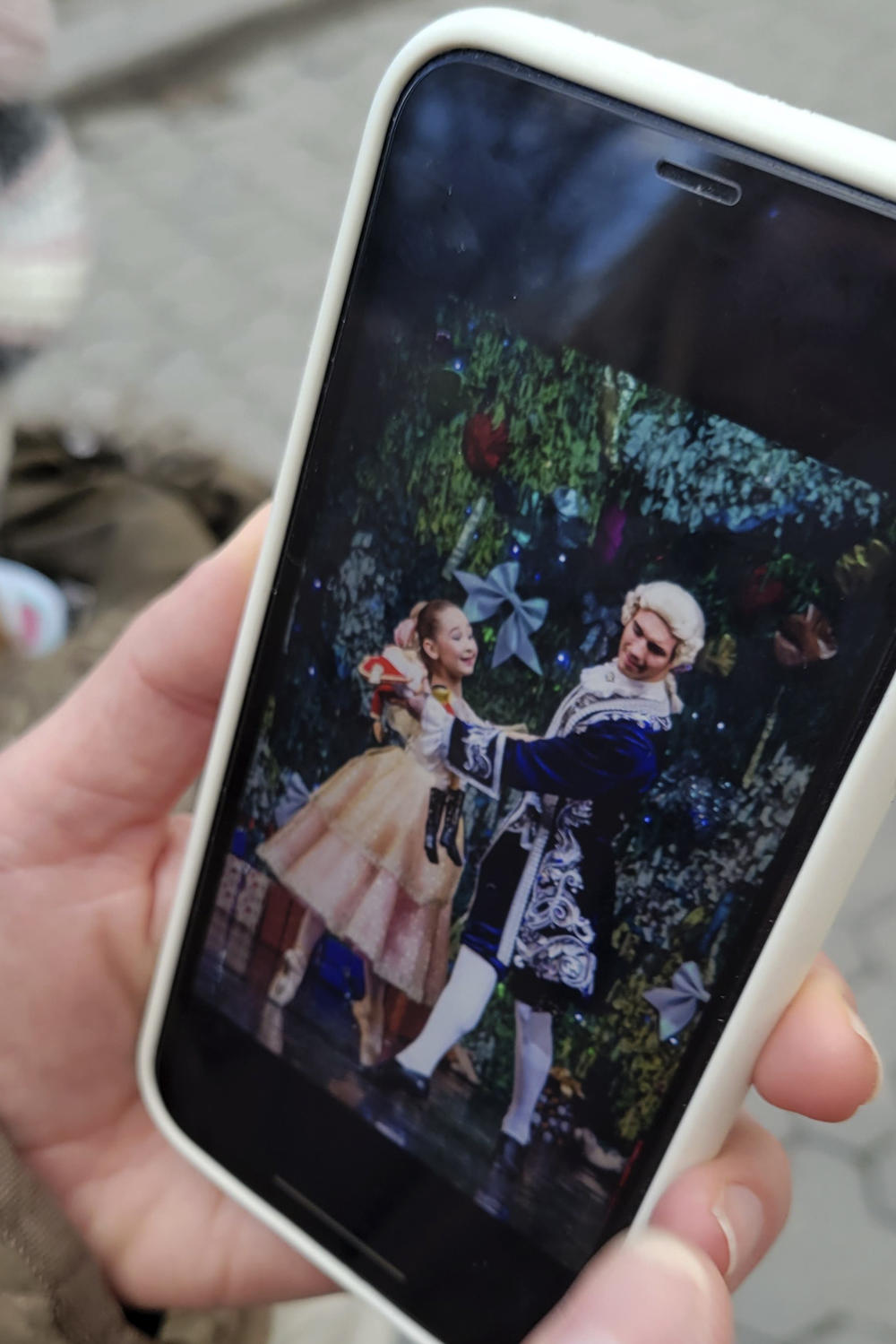 Kateryna Kltsova shows a picture on her phone of her older daughter Maria in a lavish production last Christmas of <em>The Nutcracker.</em>