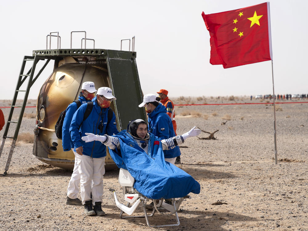 Chinese astronaut Ye Guangfu sits outside the return capsule of the Shenzhou-13 space mission after landing at the Dongfeng landing site in northern China's Inner Mongolia Autonomous Region on Saturday.