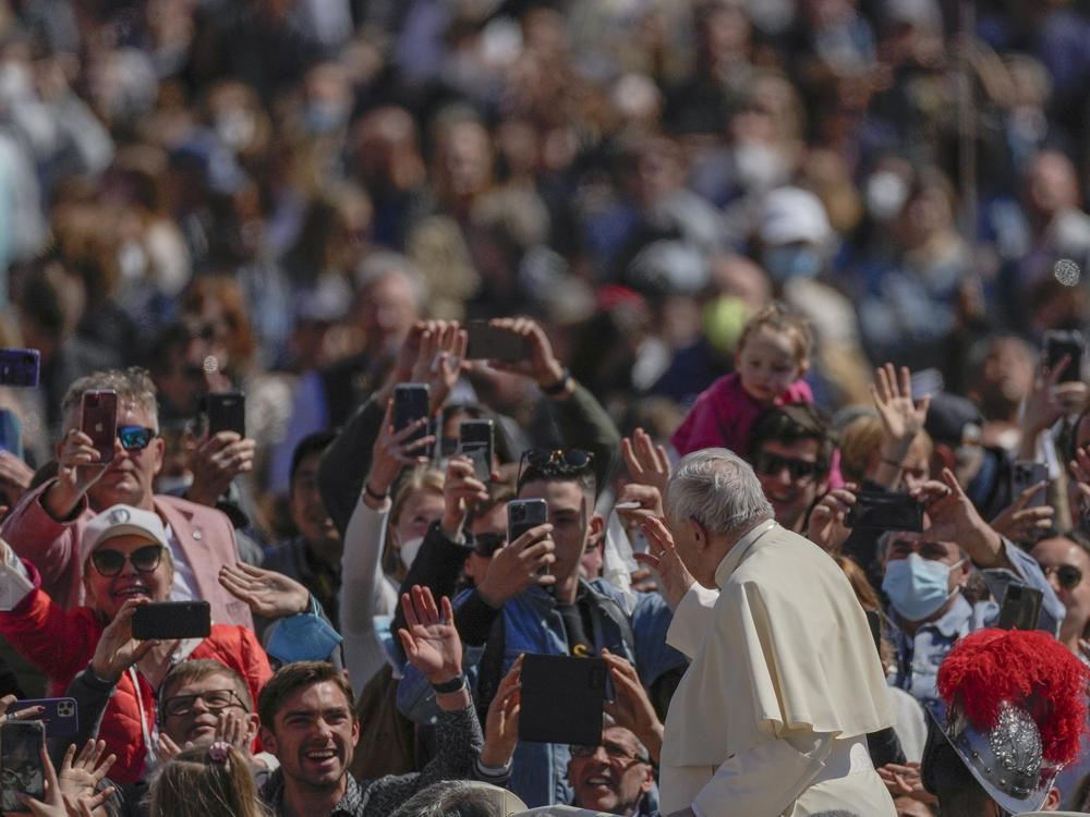 Pope Francis on his popemobile drives through the crowd of faithful at the end of the Catholic Easter Sunday mass he led in St. Peter's Square at the Vatican, Sunday, April 17, 2022.