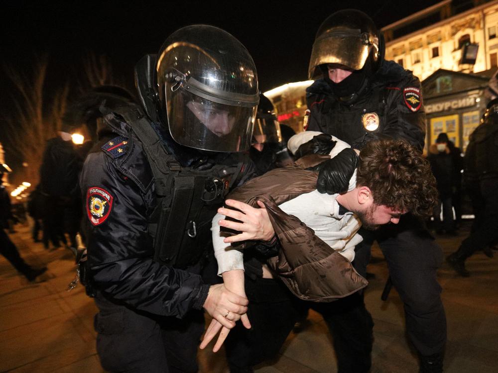 Police detain a demonstrator during a protest against Russia's invasion of Ukraine in central Saint Petersburg on February 27, 2022.