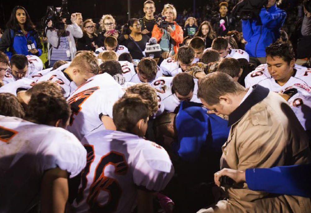 The parties included this image, of Coach Kennedy praying with a crowd after the homecoming game, in their joint appendix submitted to the Supreme Court