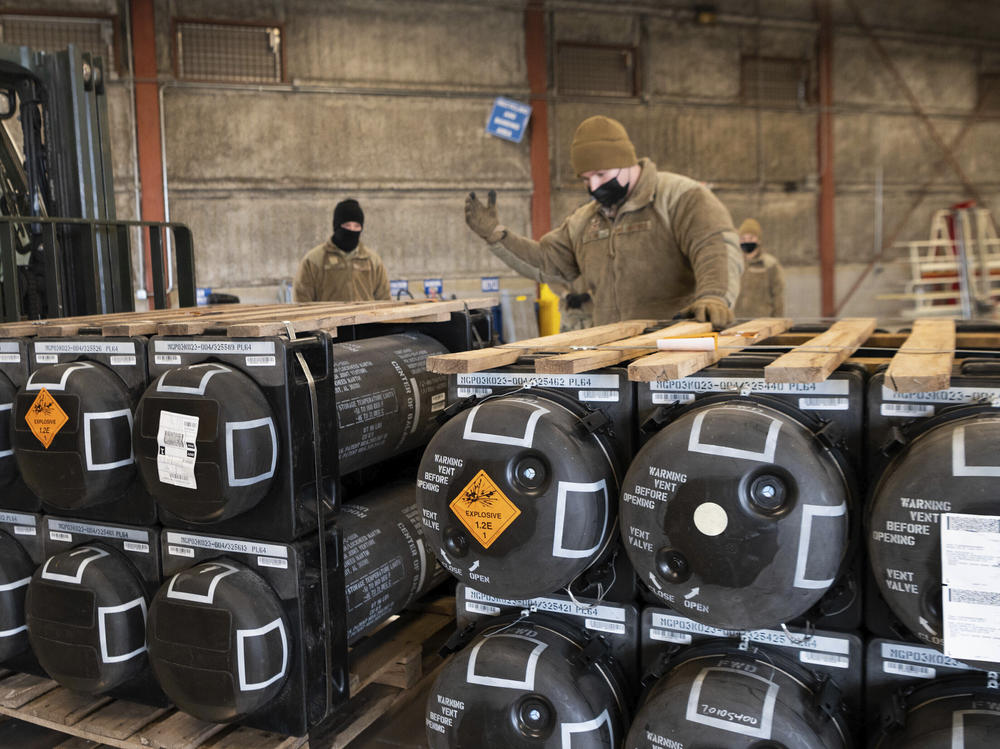Airmen and civilians from the 436th Aerial Port Squadron place ammunition, weapons and other equipment on pallets bound for Ukraine at Dover Air Force Base in Delaware on Jan. 21, 2022.