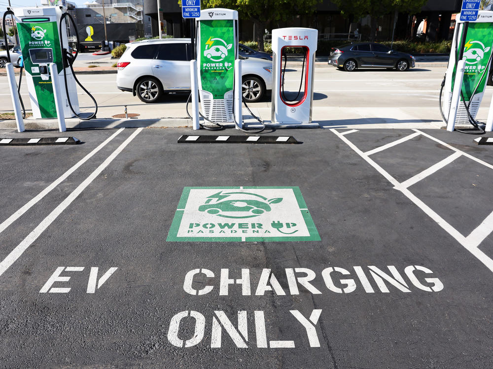 An 'EV Charging Only' sign is seen at a fast charger station for electric vehicles in Pasadena, Calif., on April 14.