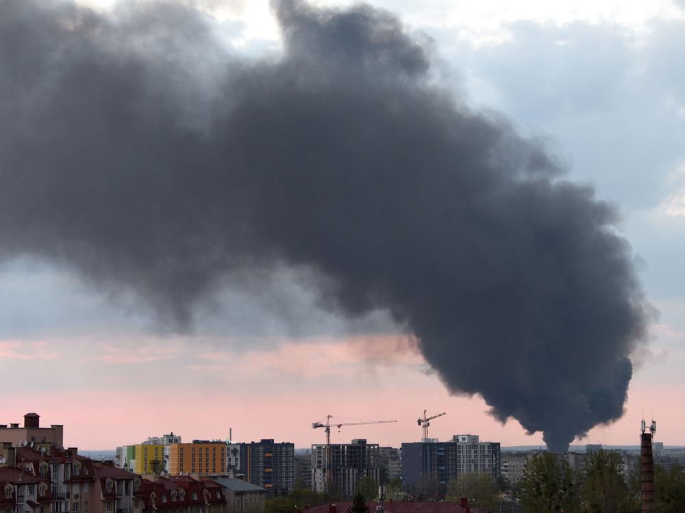 Dark smoke rises following an airstrike in the western Ukrainian city of Lviv, on Tuesday. Russia said its artillery hit hundreds of targets across the country in the past day.