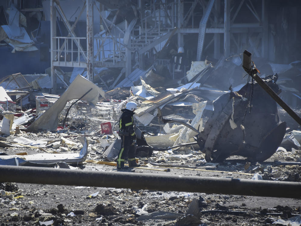 An Ukrainian firefighter works near a destroyed building on the outskirts of Odesa, Ukraine, on Tuesday. The Ukrainian military said Russian forces fired seven missiles a day earlier from the air at the crucial Black Sea port of Odesa, hitting a shopping center and a warehouse.