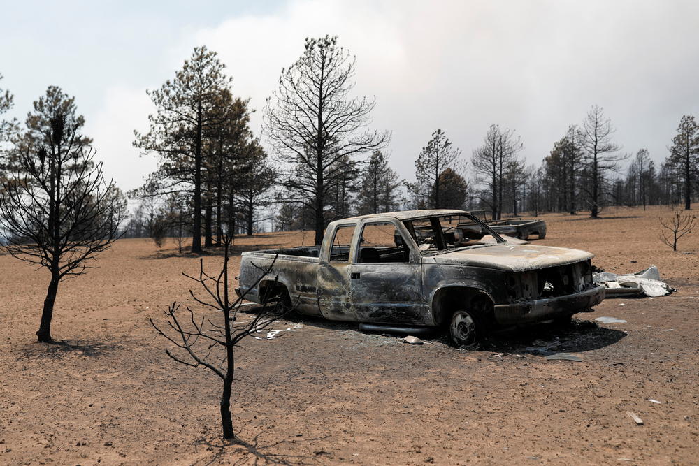 View of the remains of Michael Salazar's car, burned during the Hermits Peak and Calf Canyon fires, in Tierra Monte, New Mexico.