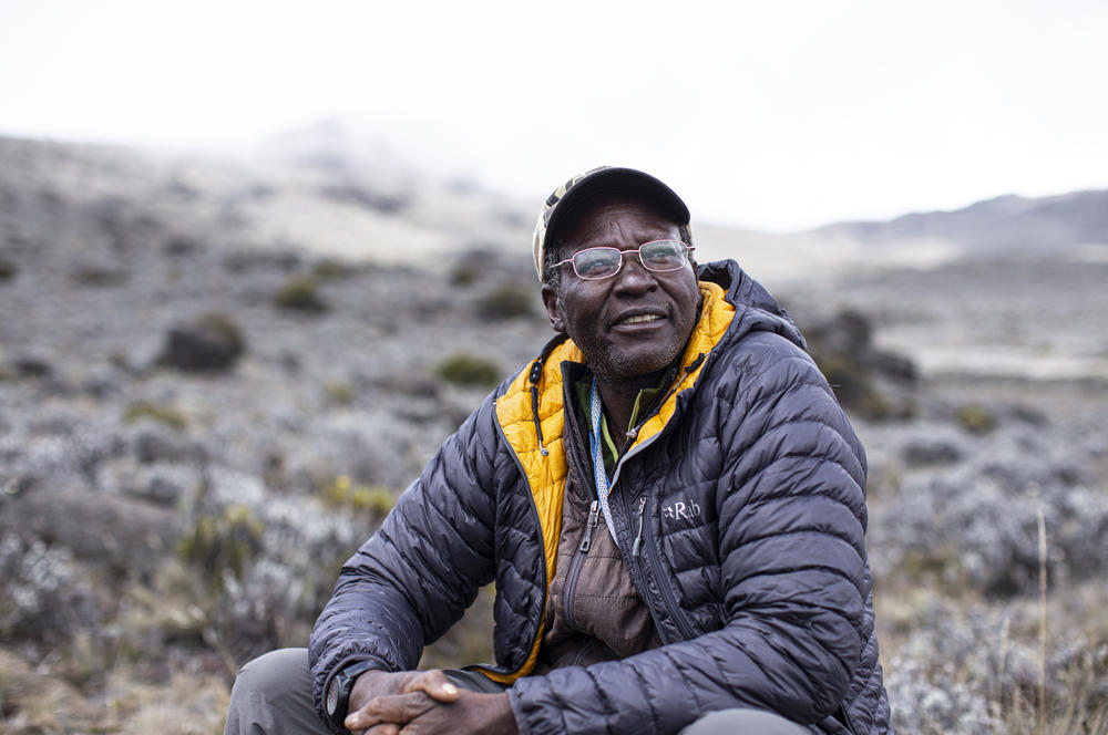 Kagambi rests on a climb of Mount Kilimanjaro in Tanzania. He says we have much to learn from the outdoors. 