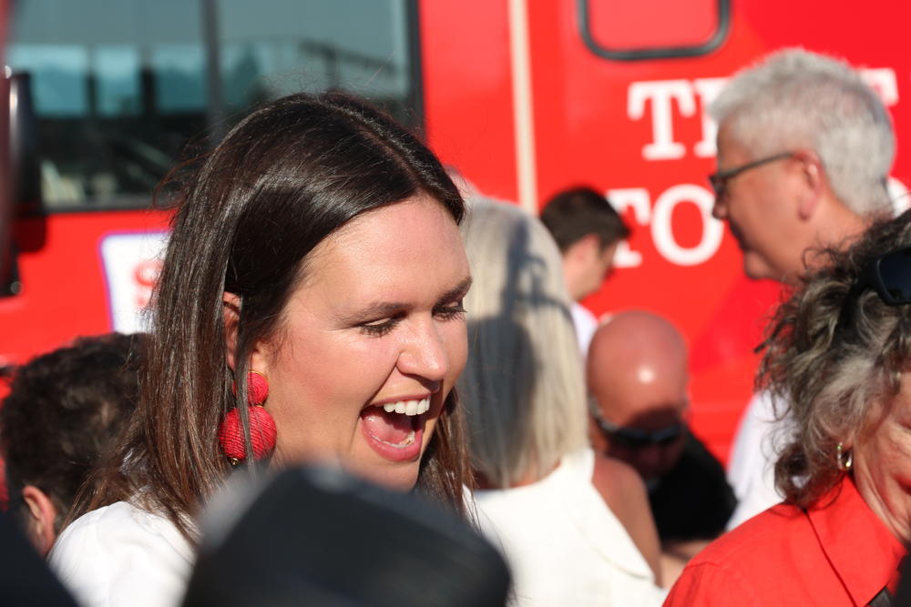 While campaigning, Sarah Huckabee Sanders laughs and mingles with voters in Benton, Ark. on Sept. 6, 2021. Sanders was running in the GOP primary for governor in Arkansas.