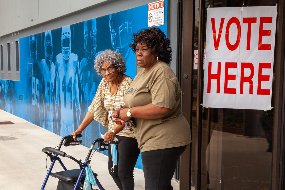 Valerie Shepherd, right, walks with her mother, Thelma Tolbert after voting in the Alabama primary on Tues., May 24, 2022, at Legion Field Stadium in Birmingham, Alabama.