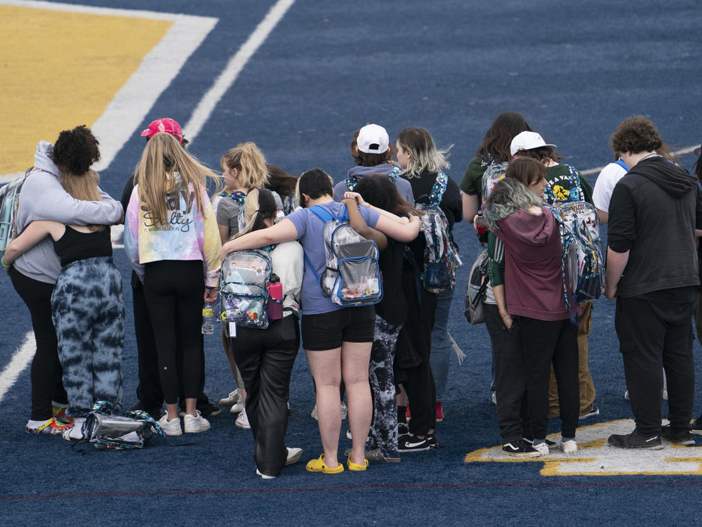 Oxford High School students embrace each other during Thursday's walkout.