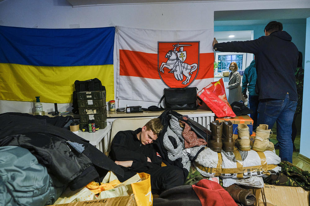 A volunteer sleeps in the Belarusian House, a cultural center in Warsaw, while waiting to leave for Ukraine. Many Belarusians have come to enlist in a battalion named after Kastus Kalinouski, a writer and revolutionary who was the driving force behind Belarusian nationalism in the 19th century.