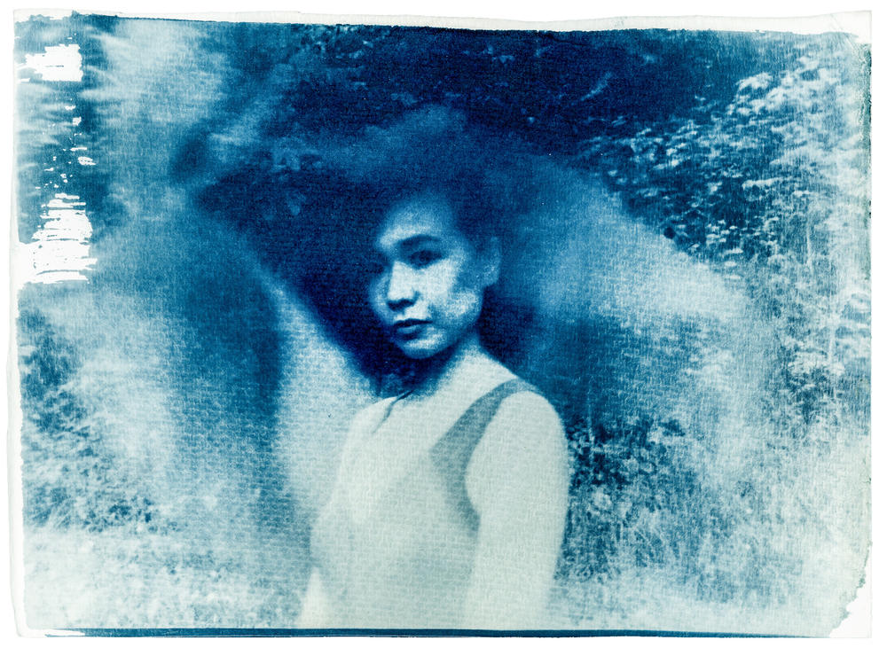 Self portrait, Rock Creek Park, Washington, D.C., May 2022. The texture and color of the cyanotype looks similar to a shanku, an everyday outfit worn by the Hakka ethnic group in China of which Shuran Huang proudly belongs. Worn by men and women of all ages, a shanku is usually blue and black, with little ornamentation.