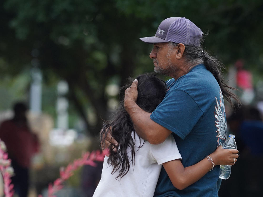 Families hug outside the Willie de Leon Civic Center where grief counseling will be offered in Uvalde, Texas, on May 24.