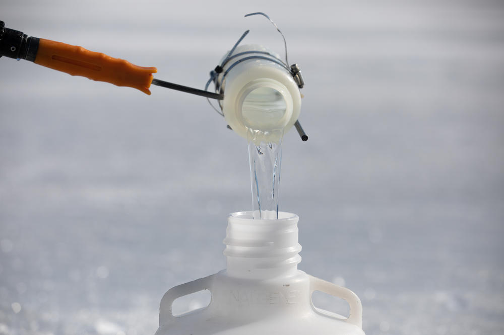 Water samples from Lake Huron are transferred to a plastic bottle on Feb. 15.