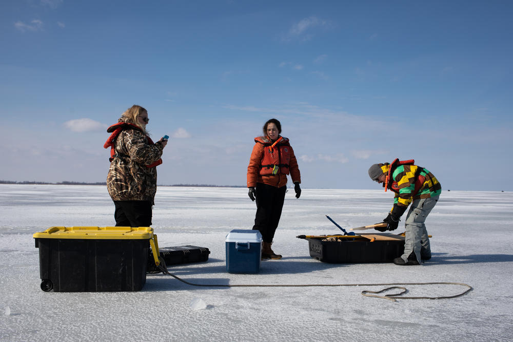 Wetland Ecology Lab Managers Bridget Wheelock and Allison Kneisel and Great Lakes Restoration Wetland Field Crew Leader Matt Sand collect samples in Saginaw Bay on Feb. 15.