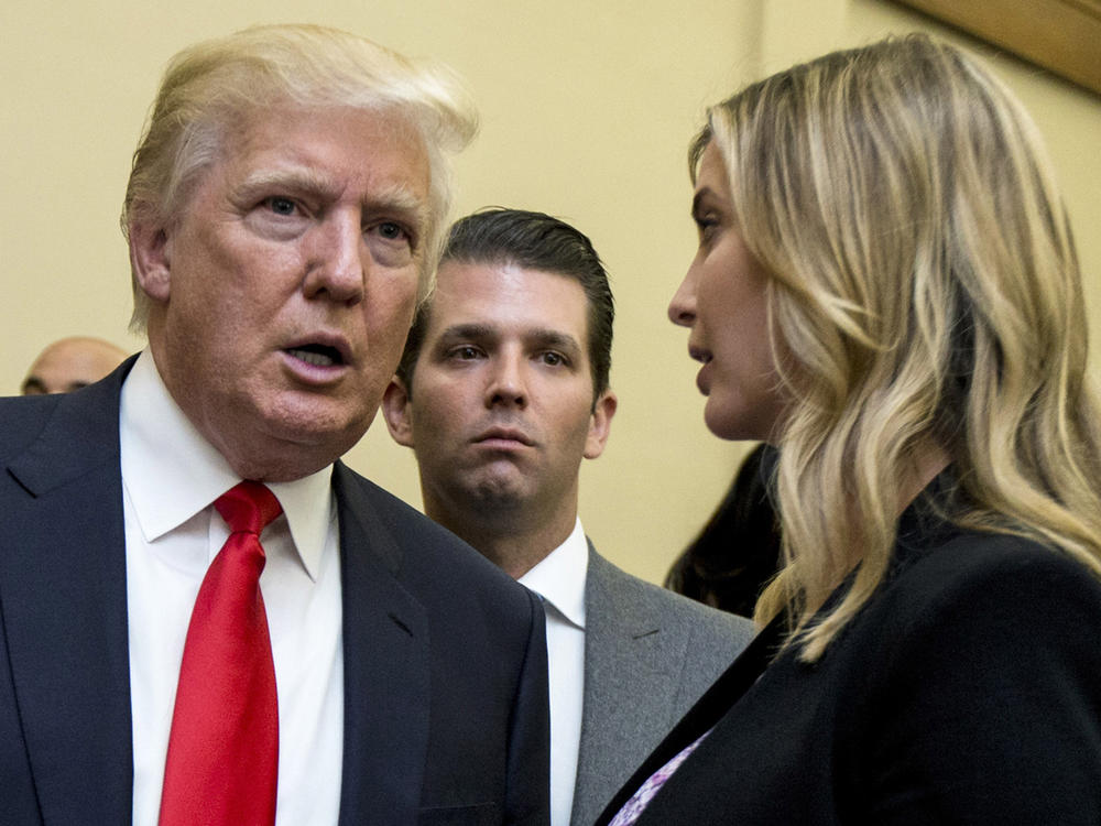 Donald Trump, left, his son Donald Trump Jr., center, and his daughter Ivanka Trump speak during the unveiling of the design for the Trump International Hotel in Washington, on Sept. 10, 2013.
