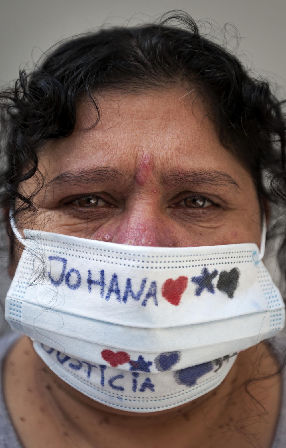 Marta Ramallo, the mother of Johanna Ramalla. The bottom of her face mask reads 