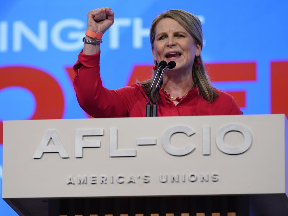 Elizabeth Shuler, president of the AFL-CIO, introduces President Biden before he addresses the labor federation's convention on Tuesday in Philadelphia. On Sunday Shuler was elected to a four-year term as AFL-CIO president.