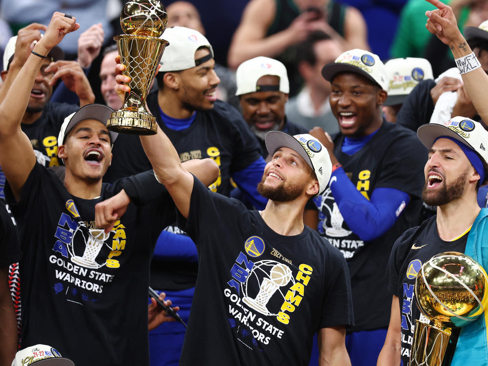 Stephen Curry raises the NBA Finals Most Valuable Player Award after the Golden State Warriors defeated the Boston Celtics 103-90 in Game 6 of the 2022 NBA Finals on June 16, 2022 in Boston.