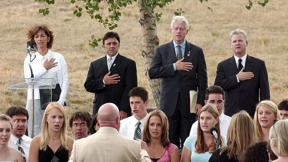 Columbine High School principal Frank DeAngelis sings in 2006 alongside former president Bill Clinton at a groundbreaking ceremony for a memorial near the school.