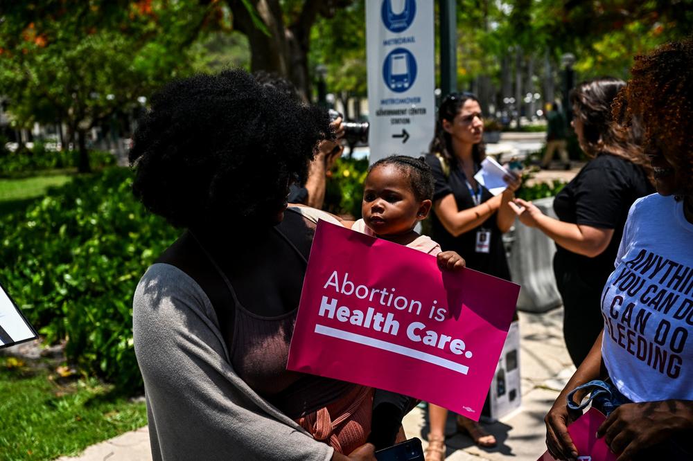 Tifanny Burks holds Novah Smith (2) during a protest organized by Florida Planned Parenthood after the 6-3 ruling in Dobbs v. Jackson Women's Health Organization in Miami, Fla., on June 24.
