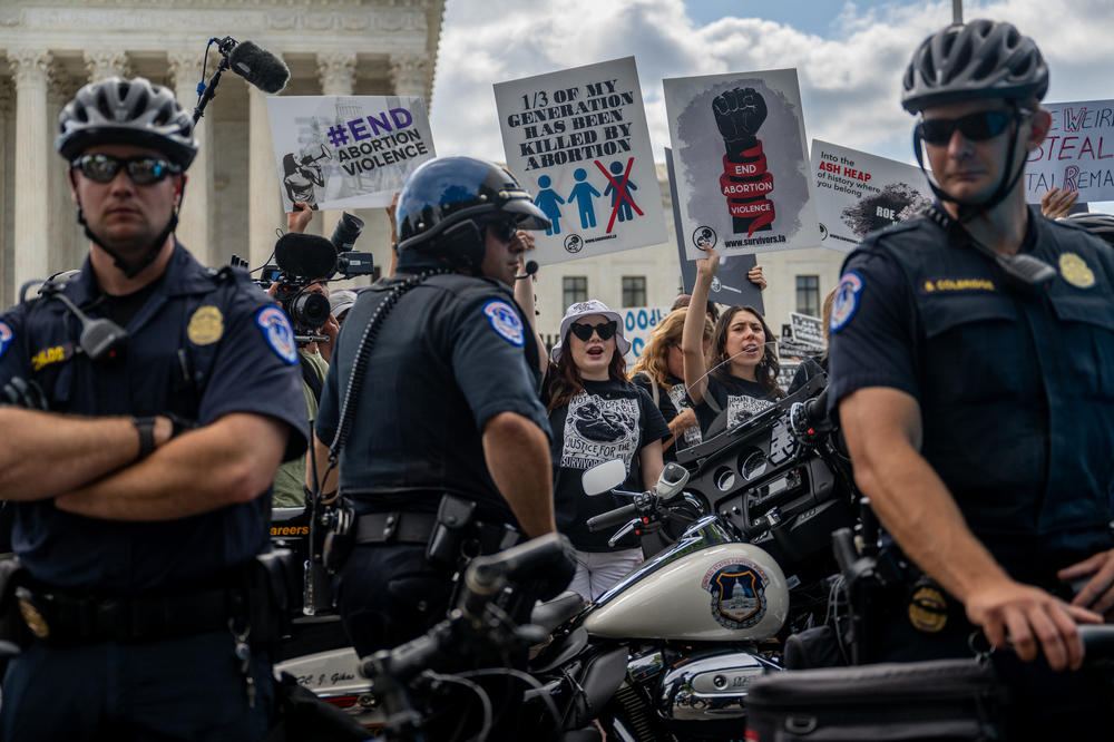 Demonstrators protest in front of the Supreme Court moments before the Dobbs v. Jackson Women's Health Organization ruling on June 24, in D.C.