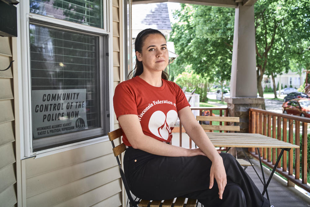 Kellie Lutz, a former barista at Stone Creek Coffee who led the union campaign there in 2019, sits on the porch of her home in Milwaukee. Lutz is now a certified nursing assistant and a shop steward in a health care union.