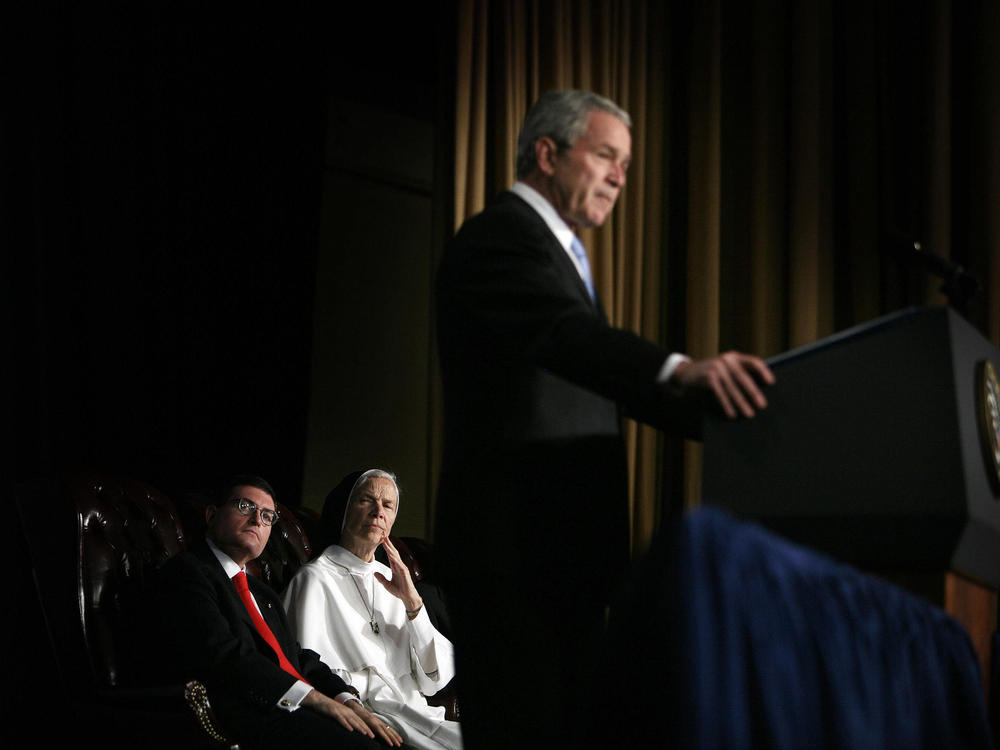 Leonard Leo (left) watches as then-President George W. Bush speaks at the National Catholic Prayer Breakfast in 2007.