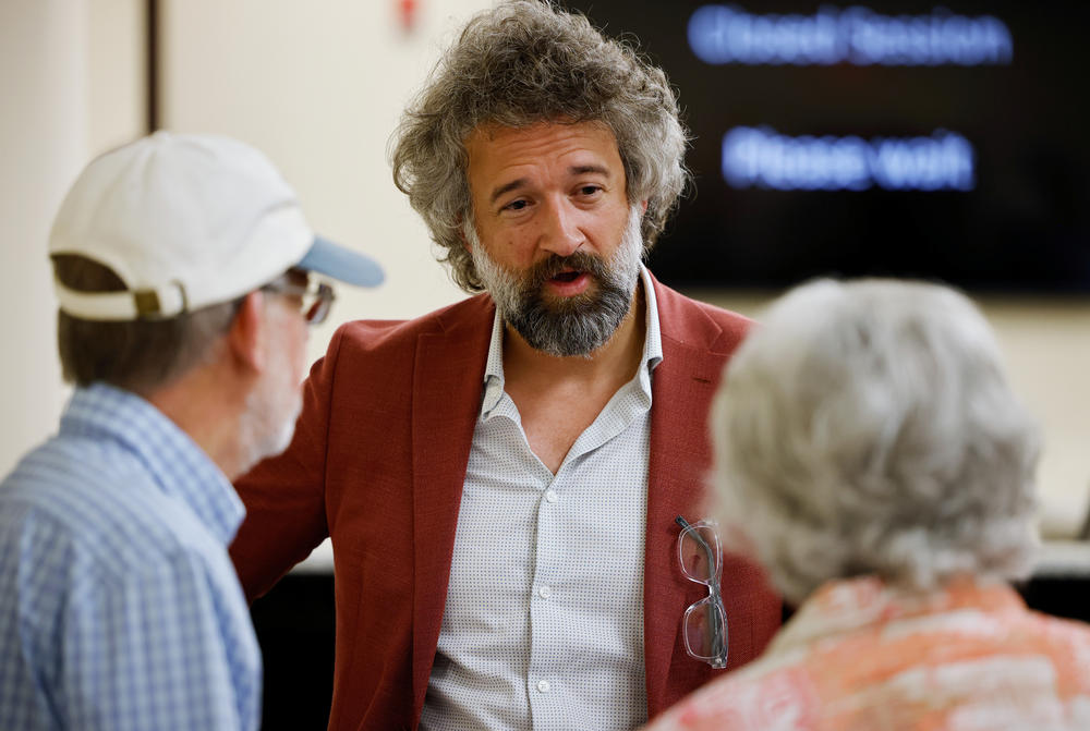 David Clements talks to audience members after speaking to the Surry County board of commissioners during a presentation by several individuals that aimed to cast doubt on election integrity, urging the commission to replace existing voting machines with purely paper ballots in Dobson, N.C., on May 16.