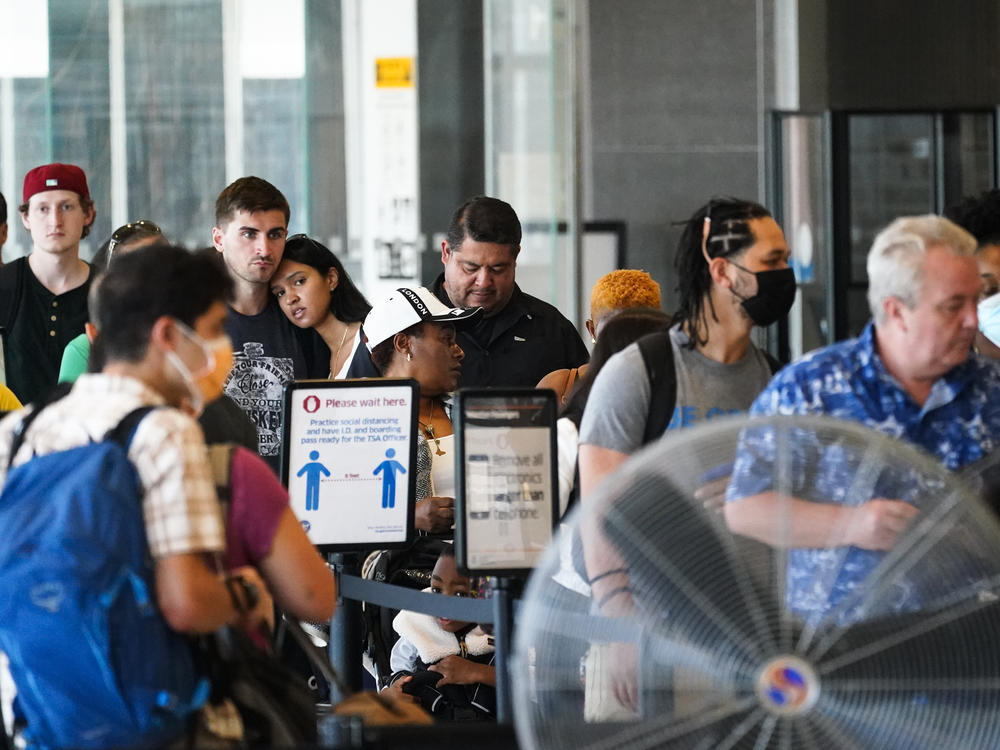 Travelers wait in a security line at the Philadelphia International Airport ahead of the July Fourth weekend in Philadelphia on Friday.