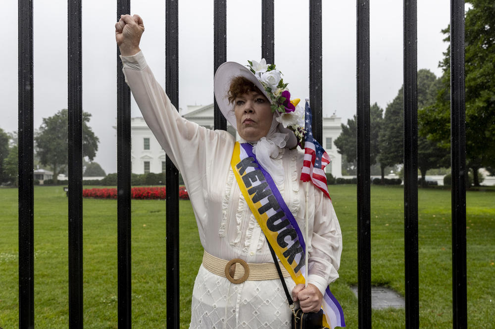 Renea Delong from Bowling Green, Kentucky stands in front of the White House as the march arrives. 