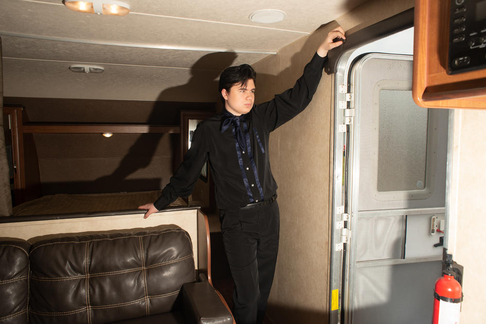 Bryson Vines waits in a trailer before performing at the Michigan Elvisfest on Friday, July 8.