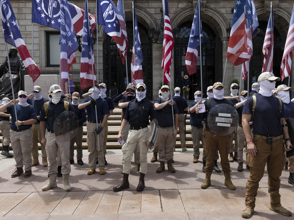 People bearing the insignia of the white supremacist group Patriot Front stand in front of the Boston Public Library in Copley Square on Saturday, July 2, in Boston.
