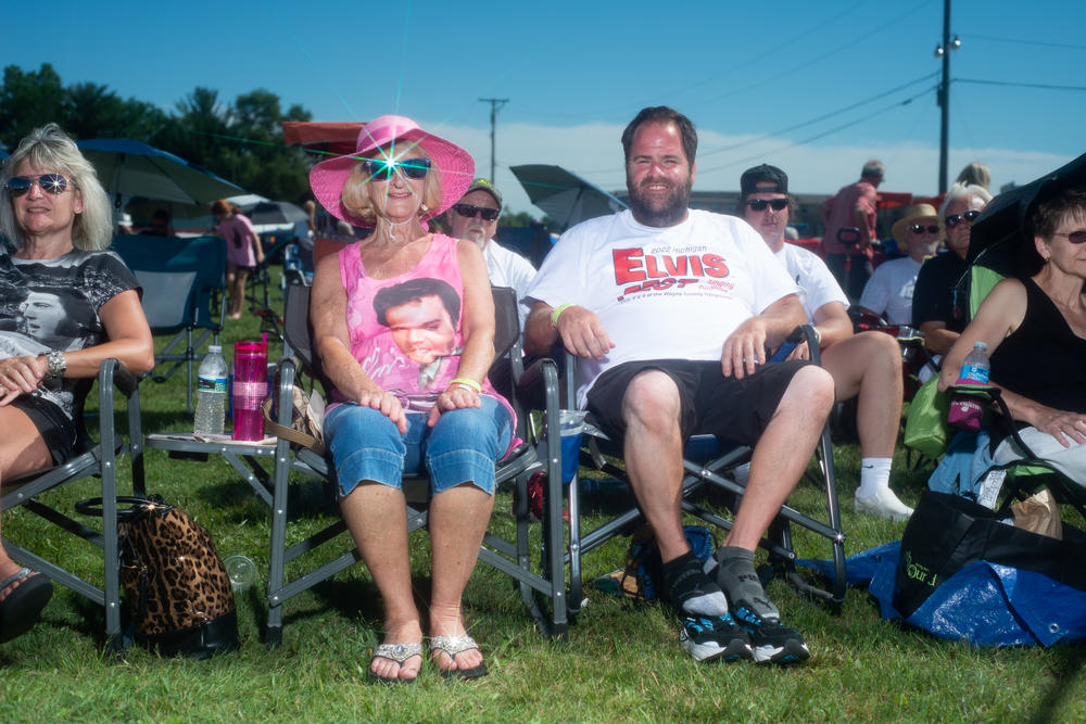 A couple waits between performances at the Michigan Elvisfest on Saturday, July 9.