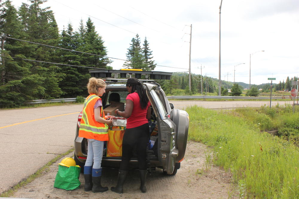 Environmental students Jaynina Deku and Valérie Bolduc review equipment in their Concordia University research vehicle.