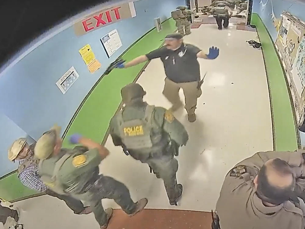 In this photo from surveillance video provided by the Uvalde Consolidated Independent School District via the Austin American-Statesman, authorities respond to the shooting at Robb Elementary School in Uvalde, Texas, on May 24, 2022.