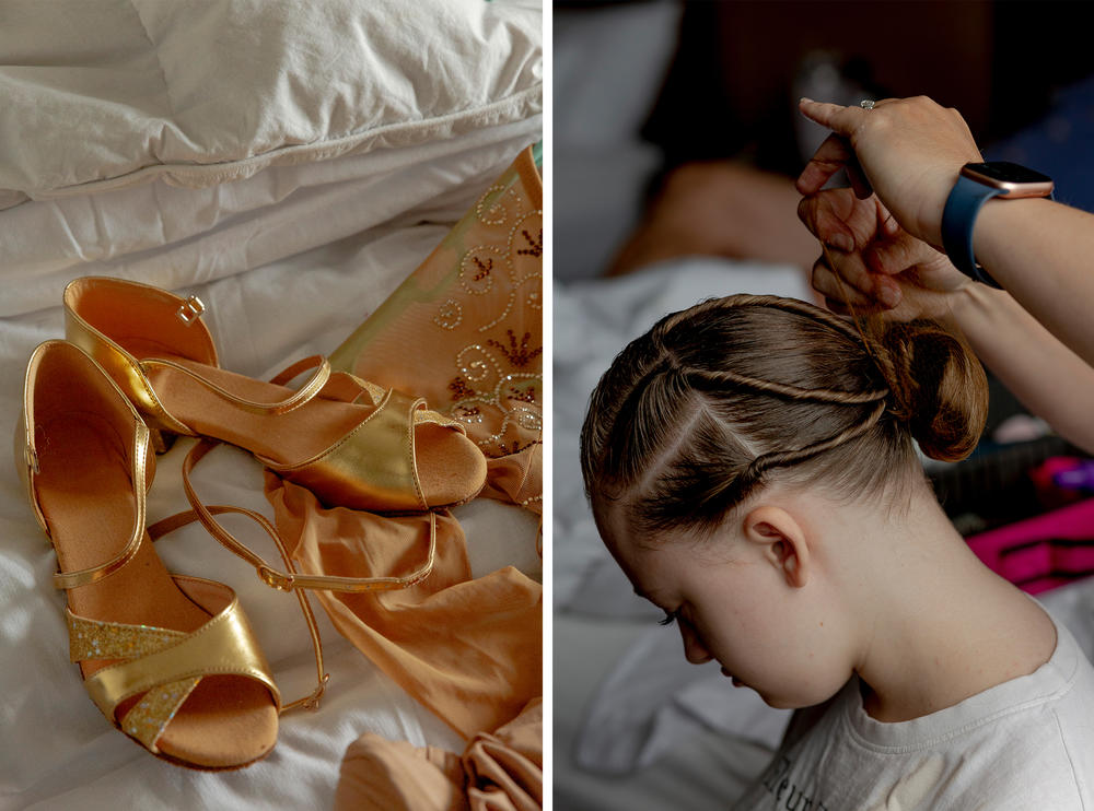 Eve Dahl's mother does her hair as her dance shoes and competition dresses lay out on a hotel room bed.
