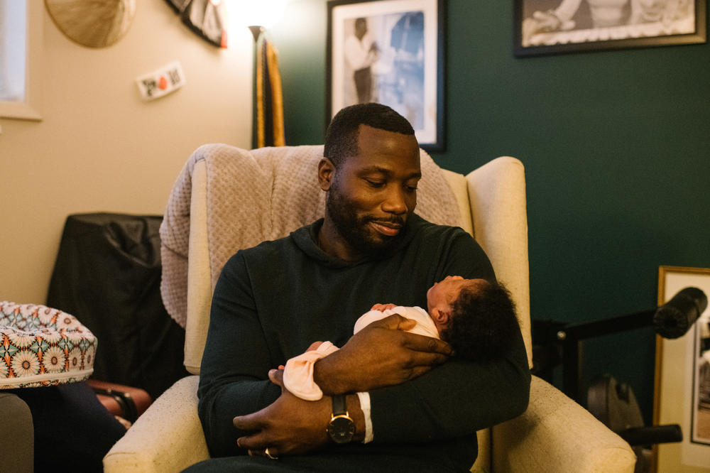 Jerry Jean-Louis cradles his newborn daughter minutes after returning home from the hospital. Of how Kemp helped his wife to advocate for her birthing rights, he said, 