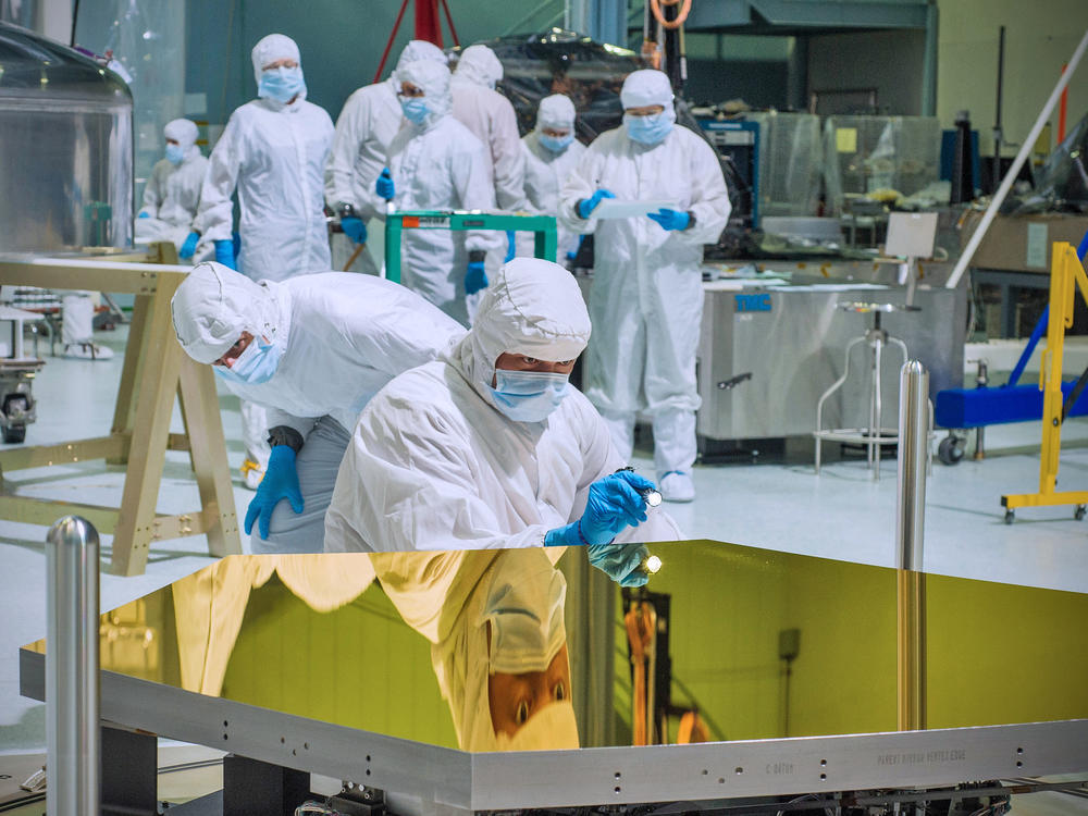 NASA technicians and scientists examine one of the James Webb Space Telescope's mirrors at the Goddard Space Flight Center in Greenbelt, Md.