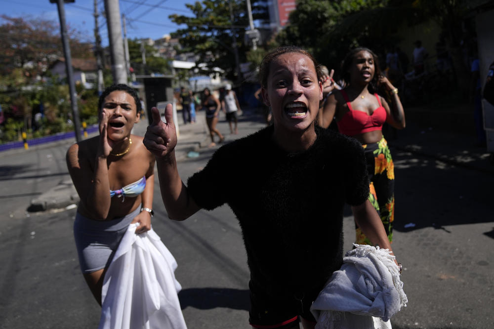 Residents shout at police in protest against a police operation that resulted in multiple deaths, in the Complexo do Alemao favela in Rio de Janeiro on Thursday.