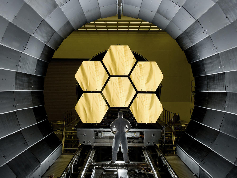 NASA engineer Ernie Wright looks on as the first flight-ready mirrors for the James Webb Space Telescope are prepared to undergo testing.