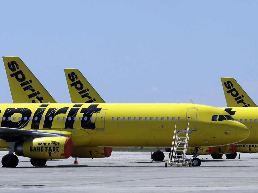 A line of Spirit Airlines jets sit on the tarmac at the Orlando International Airport on May 20, 2020, in Orlando, Fla.