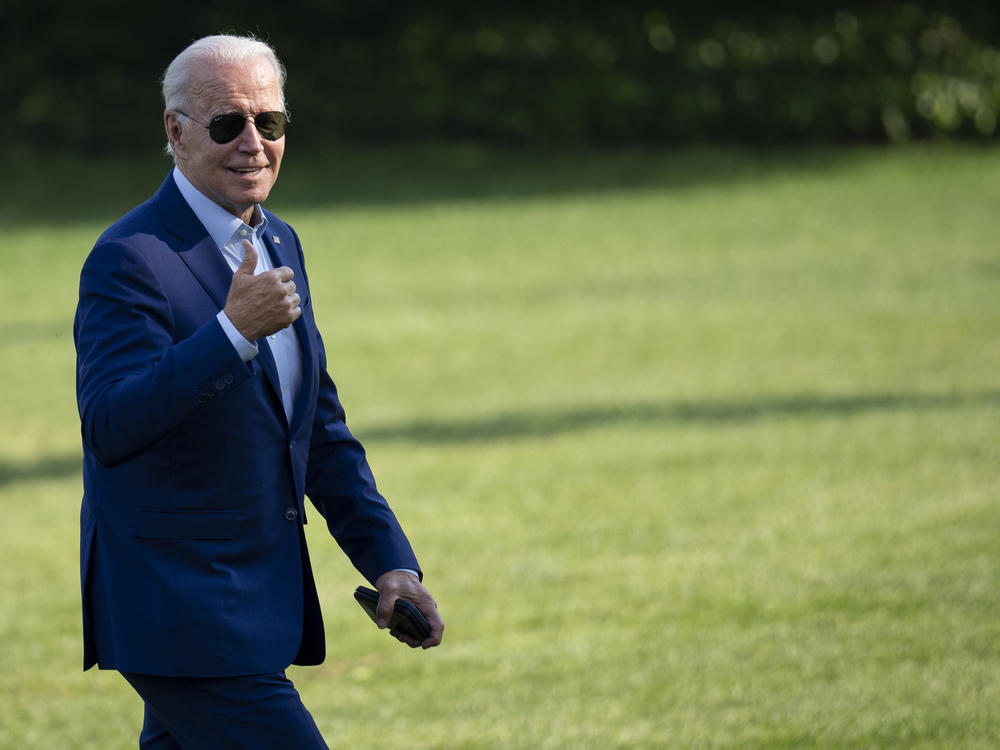 President Joe Biden gestures toward reporters as he departs Marine One and walks to the Oval Office on the South Lawn of the White House on July 20.