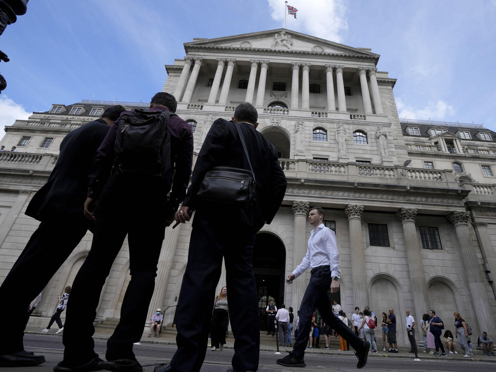 People wait at the Bank of England in London, Thursday, Aug. 4, 2022.
