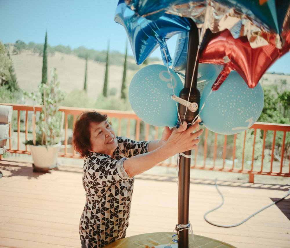 Perez, the owner of a small assisted-living facility in El Dorado Hills, Calif., puts the finishing touches on preparations for a party for one of Hillcrest Care's residents on July 14, 2022, ahead of their 97th birthday celebration.