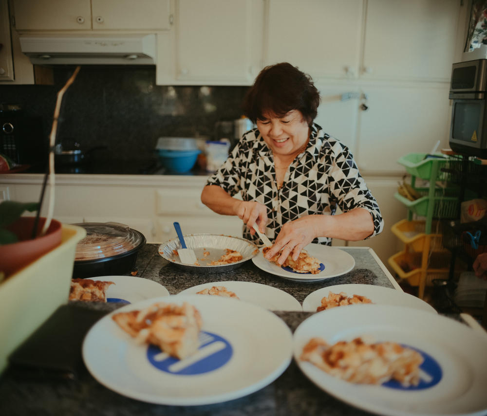 Perez prepares food for residents of Hillcrest Care, the small assisted-living facility she owns in El Dorado Hills, Calif., on July 14, 2022. When Filipino fare is on the day's menu, Perez says she often does the cooking herself.
