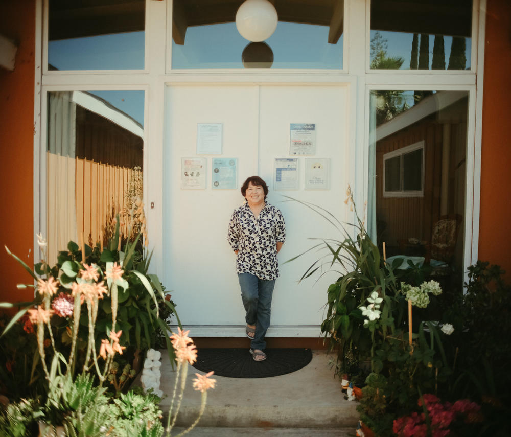Angelita Perez, the owner of Hillcrest Care, a small assisted-living facility in El Dorado Hills, Calif., stands outside the facility, ready to greet visitors on July 14, 2022.