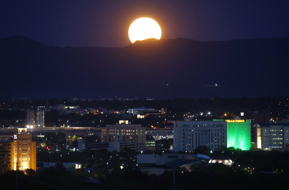 Albuquerque, New Mexico: The Sturgeon Moon rises beyond the city.