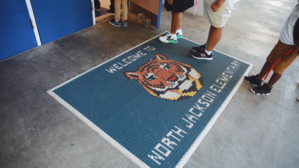 Students wait in line to check in for the first day of school at North Jackson Elementary. As they walk in, they are greeted by their school mascot, the tiger.