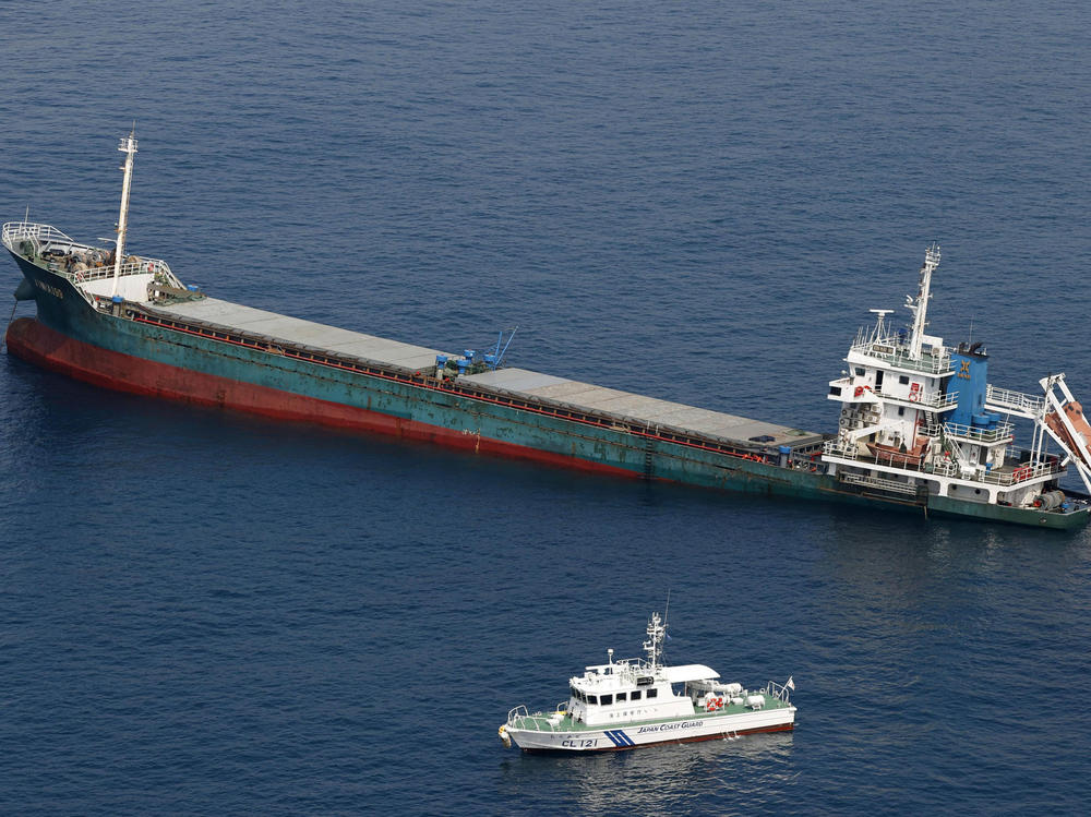 This aerial photo shows Belize-registered cargo ship Xin Hai 99 after a collision off of Kushimoto, Wakayama prefecture in southwestern Japan on Saturday.